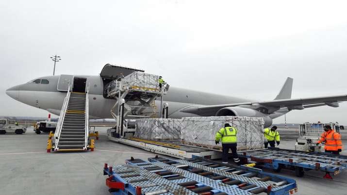 Boxes containing vaccines are unloaded from a Hungarian