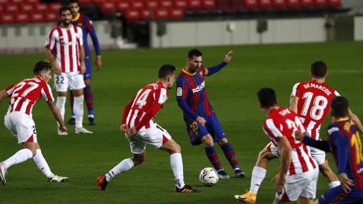 Barcelona's Lionel Messi, center, plays the ball during the