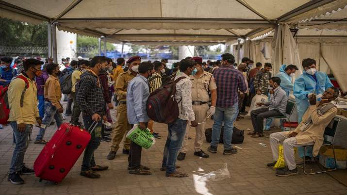 Passengers await their turn to be tested for COVID-19. 