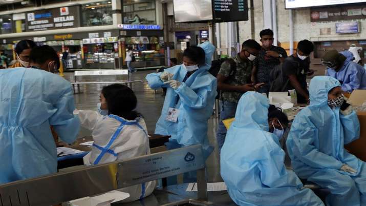 Health workers prepare to takes swab samples to test for