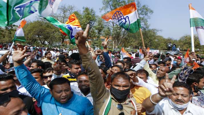 Congress party workers and supporters gather outside the
