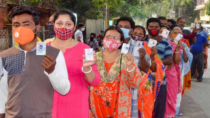 Voters wait in a queue to cast their vote at a polling