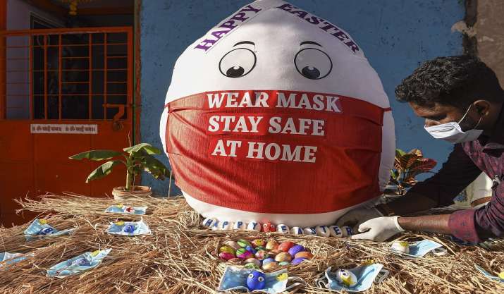 A man gives final touches to Easter eggs with a message on