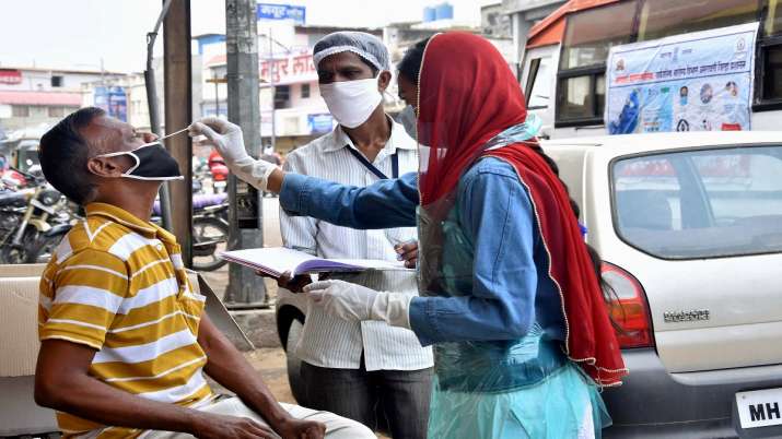 A health worker collects samples for COVID-19 testing, amid