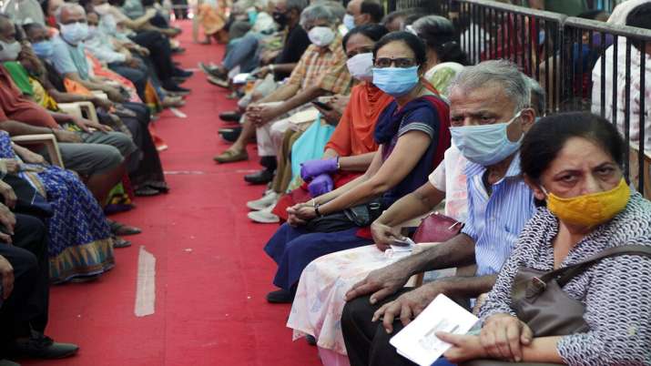 People wait to receive COVID-19 vaccine in Mumbai.