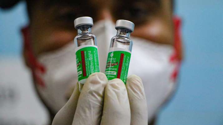A healthworker hold vials of Covishield vaccine.