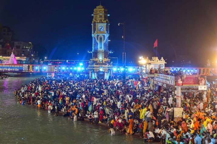 Devotees offer prayers during Ganga aarti at Kumbh Mela 2021, in Haridwar