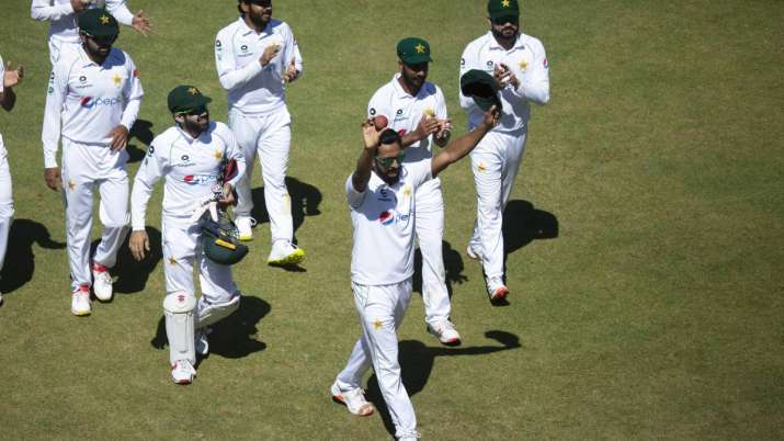 Pakistan bowler Hassan Ali ,centre, holds a cricket ball