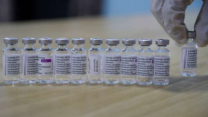 A health worker arranges the empty Covishield vaccines for