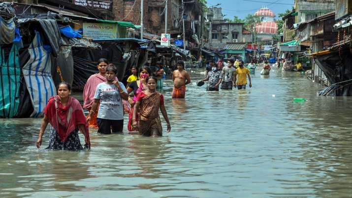 Pedestrians wade through a flooded road during landfall of