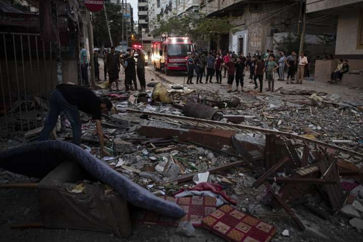 Palestinians search for survivors under the rubble of a