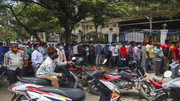 People queue up to get inoculated against the coronavirus