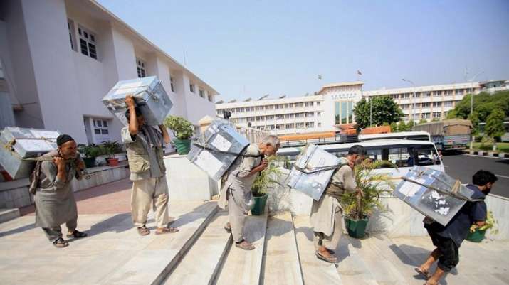 Workers carry official documents to transport them for