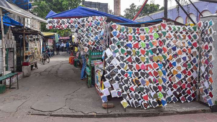 Facemasks for sale at a roadside stall as the street wears
