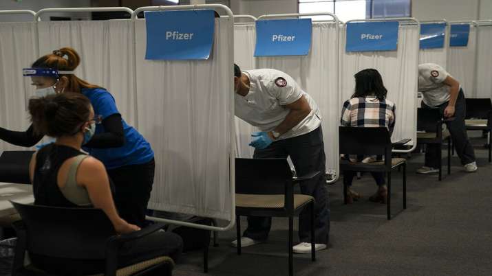 People being given shots of Pfizer vaccine against