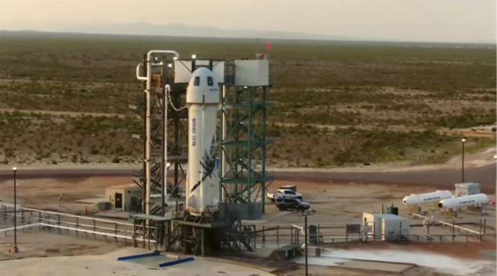 India Tv - This photo provided by Blue Origin, Blue Origin's New Shepard rocket sits on a spaceport launch pad near Van Horn, Texas, Tuesday, July 20, 2021. The rocket that is scheduled to launch later this morning will carry passengers Jeff Bezos, founder of Amazon and space tourism company Blue Origin, his brother Mark Bezos, Oliver Daemen and Wally Funk.