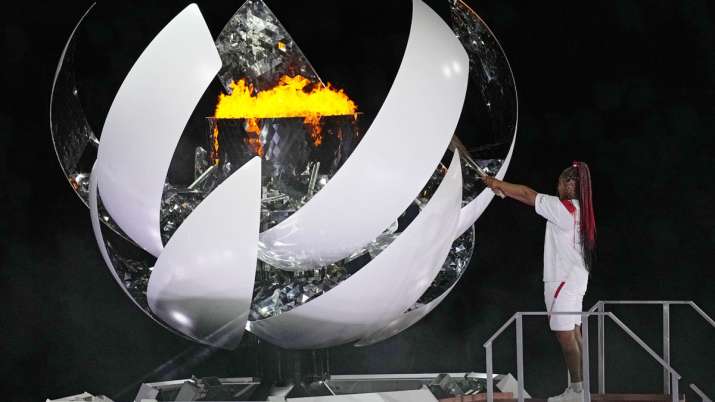 Naomi Osaka lights the Olympic flame during the opening