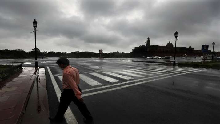 A man walking in the rain in New Delhi.  monsoon rain