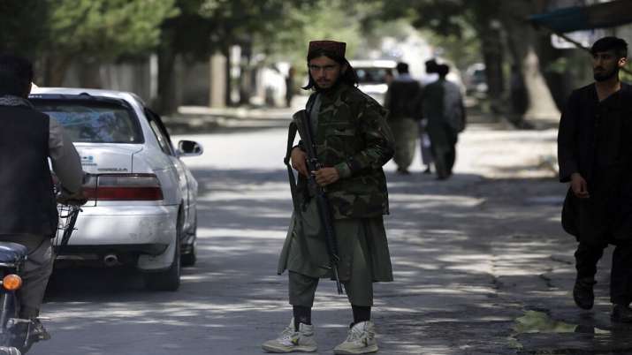 A Taliban fighter stands guard at a checkpoint in the Wazir
