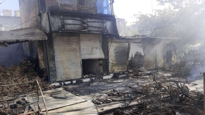 India Tv - Smoke rises from damaged shops after fighting between Taliban and Afghan security forces in Kunduz city of northern Afghanistan.