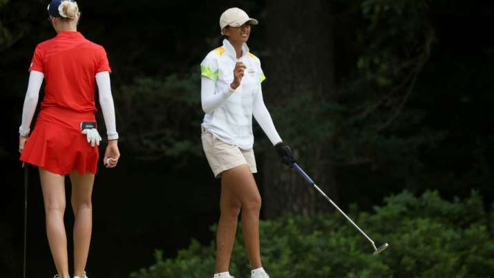 Aditi Ashok (in white) reacts after making a birdie in