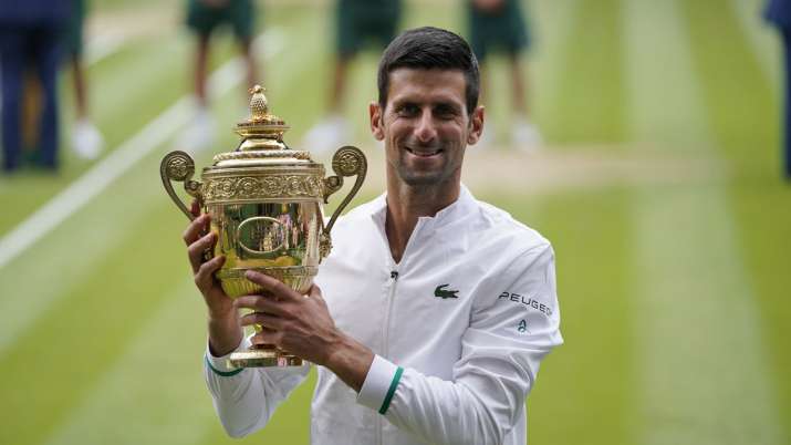 India Tv - In this July 11, 2021, file photo, Serbia's Novak Djokovic holds the trophy after his win over Italy's Matteo Berrettini in the men's singles final match of the Wimbledon Tennis Championships in London.