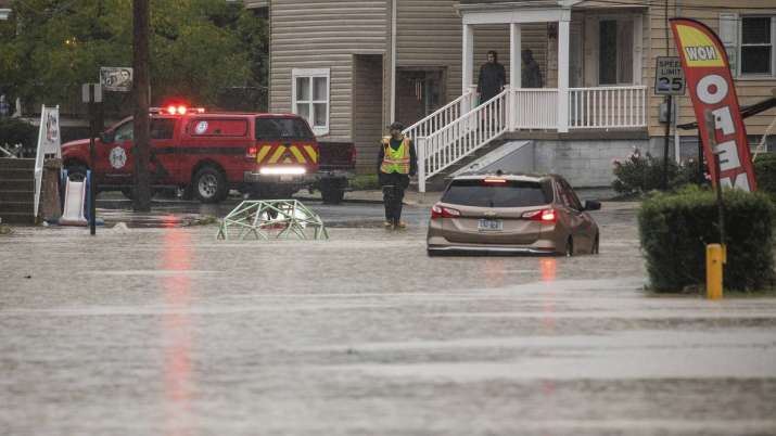 A car is stranded on a flooded street Wednesday, Sept. 1,