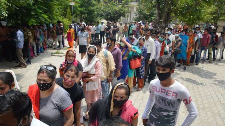 Beneficiaries wait in queues to receive COVID-19 vaccine