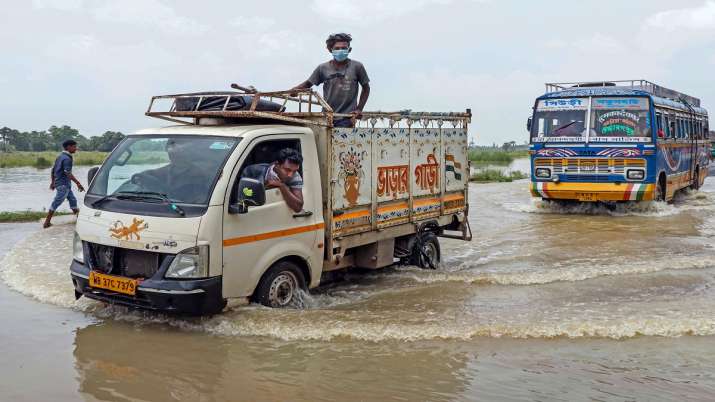 Birbhum: Vehicles wade through a flooded Suri-Katwa road at