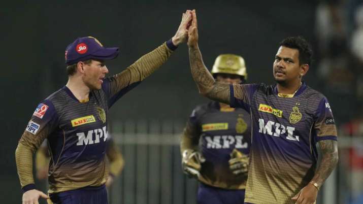 KKR's Sunil Narine (right) celebrates with captain Eoin Morgan after taking an RCB wicket in Sharjah