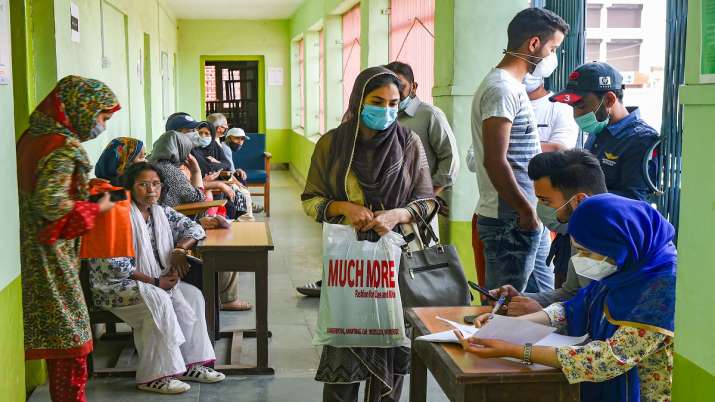 Teachers and students wait for a dose of COVID-19 vaccine