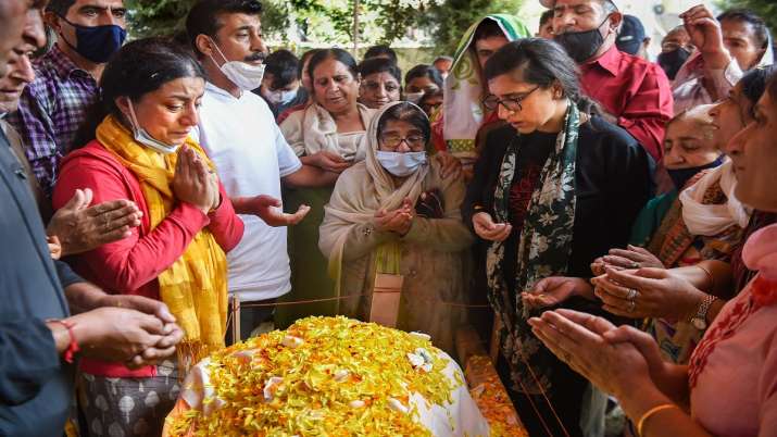 Srinagar: Relatives of M L Bindroo pray for him during his