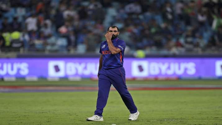 India's Mohammed Shami reacts after being hit by three