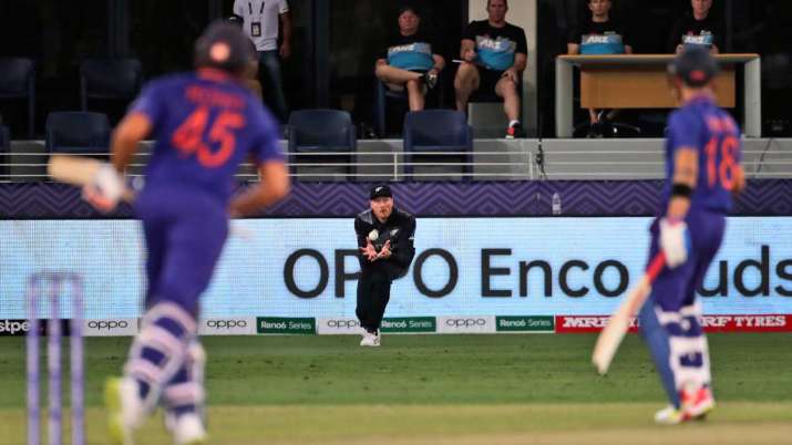 India Tv - New Zealand's Martin Guptill, center, takes the catch of India's Rohit Sharma, left, during the Cric