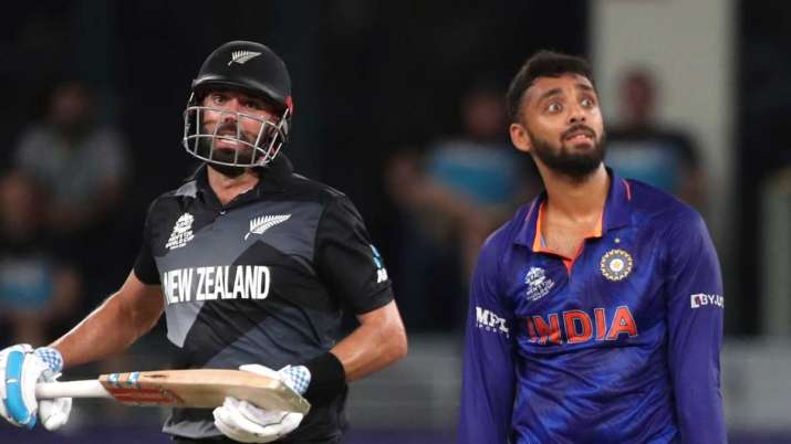 India Tv - Varun Chakraborty of India reacts after a shot by Daryl Mitchell of New Zealand during c