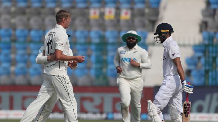 New Zealand's Kyle Jamieson, left, celebrates the wicket of India's Shubman Gill, right, during the