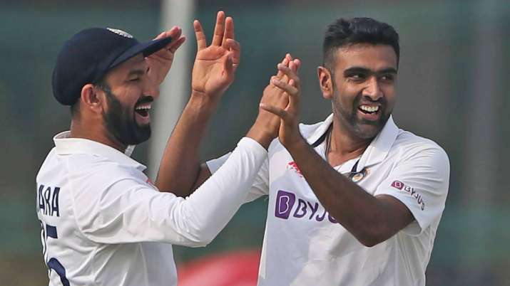 India's Ravichandaran Ashwin, right, celebrates the wicket of New Zealand's Tom Latham with his team