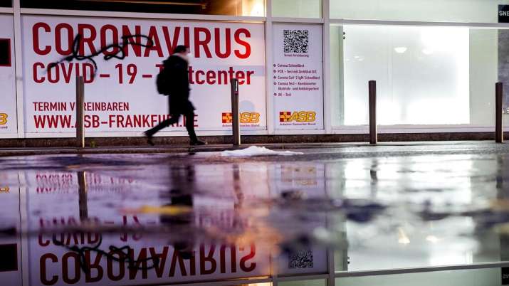 A woman walks past an abandoned coronavirus test center in