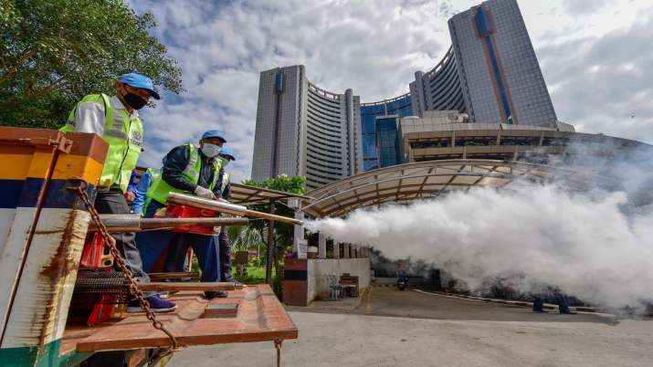 SDMC workers fumigate in a locality during the launch of a