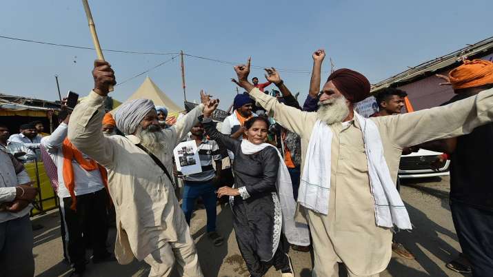 Farmers celebrate after Prime Minister Narendra Modi