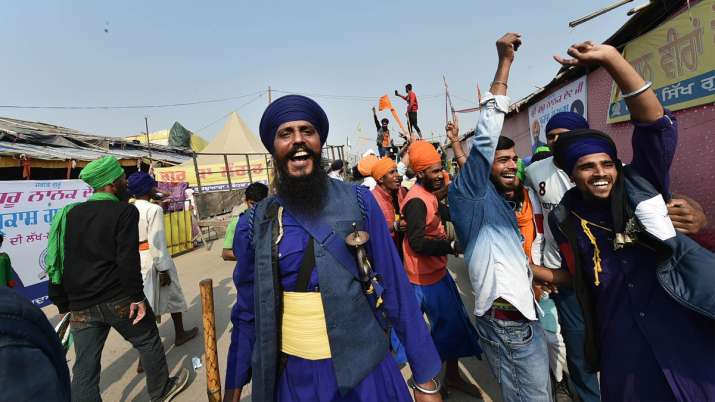 Farmers celebrate at Singhu Border in New Delhi after PM