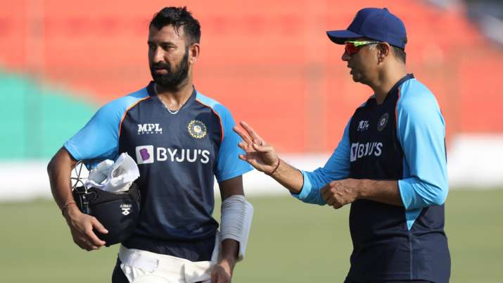 Cheteshwar Pujara gets advice from Rahul Dravid ahead of the Kanpur Test.    