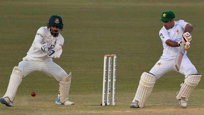Pakistan's Abid Ali (R) plays a shot as Bangladesh's wicketkeeper Liton Das watches on the fourth da