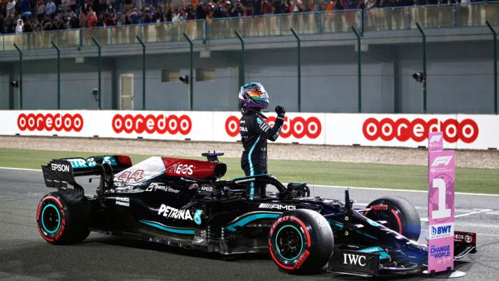 Great Britain's pole position qualifier Lewis Hamilton and Mercedes GP celebrate at Parc Ferme dur