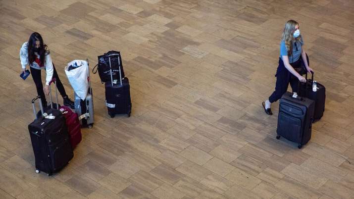 Travelers wearing protective face masks as concern over new