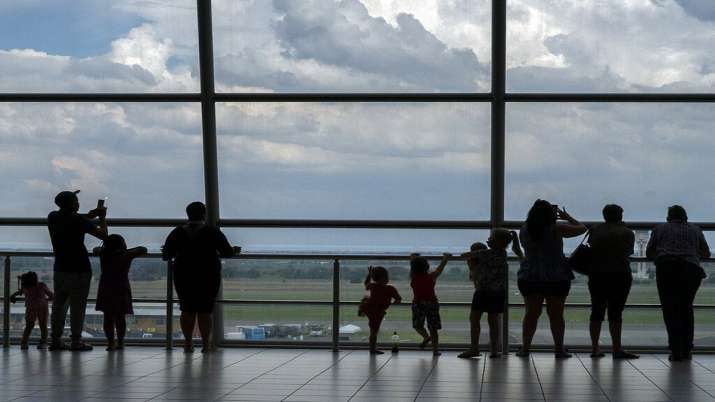 Families watch planes on the tarmac at Johannesburg's OR
