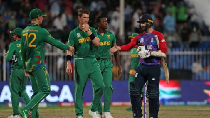 Mark Wood exchanges happiness with South African cricketers after England's win in Sharjah. 