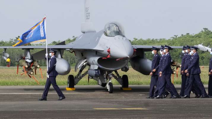 Taiwanese Air Force personnel pass by one of the newly