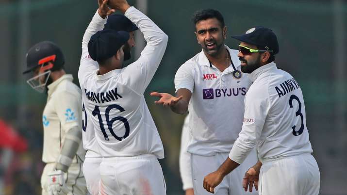 India's Ravichandaran Ashwin, centre, celebrates the wicket of New Zealand's Tom Latham with his tea