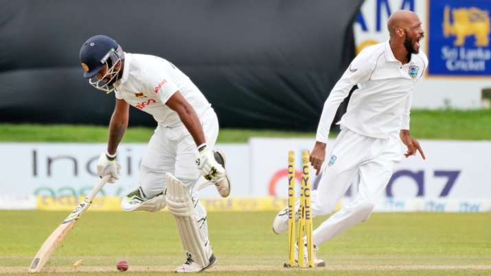 West Indies bowler Roston Chase reacts as Sri Lankan captain Dimuth Karunaratne is run out during th